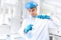 Scientist doctor using laboratory flask for taking samples from test tube