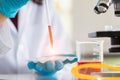 Scientist dropping liquid to sample tray