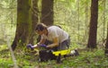 Scientist ecologist in the forest taking samples of moss Royalty Free Stock Photo