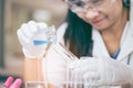 Scientist with equipment and science experiments ,laboratory glassware containing chemical liquid Royalty Free Stock Photo