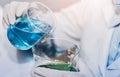 Scientist with equipment and science experiments laboratory glassware containing chemical liquid Royalty Free Stock Photo