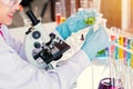 Scientist with equipment and science experiments, laboratory glassware containing chemical liquid for research or analyzing a Royalty Free Stock Photo