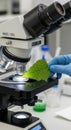 Scientist examines leaf sample under microscope in modern laboratory setting Royalty Free Stock Photo