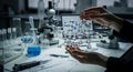 Scientist examines molecular structure in a laboratory with microscope and glassware setup Royalty Free Stock Photo