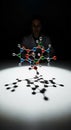 Scientist Examines Molecular Structure Under Dramatic Lighting in a Dark Room Royalty Free Stock Photo