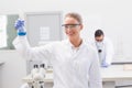 Scientist examining blue precipitate in baker Royalty Free Stock Photo