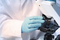 Scientist examining sample on slide under microscope, closeup Royalty Free Stock Photo