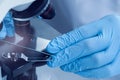 Scientist examining sample on slide under microscope, closeup Royalty Free Stock Photo