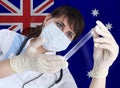 Scientist female with test tube COVID-19 against Australia flag. Research of viruses in laboratory for prevention