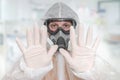 Scientist with FFP3 respirator mask is showing STOP gesture Royalty Free Stock Photo