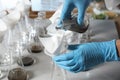 Scientist filtering soil samples at table. Laboratory analysis