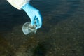 Scientist with florence flask taking sample from river for analysis, closeup Royalty Free Stock Photo