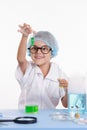 Scientist girl happily looking at test tube with liquid