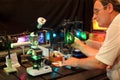 Scientist with glass demonstrate laser