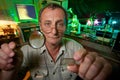 Scientist with glass, loupe pose in his lab