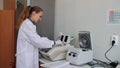 Scientist with gloved hand putting DNA sample into real-time PCR-cycler