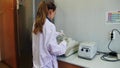 Scientist with gloved hand putting DNA sample into real-time PCR-cycler