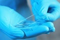 Scientist in gloves holding many microscope slides, closeup