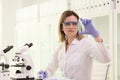 Scientist in goggles examines condition of blue reagent Royalty Free Stock Photo