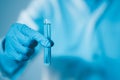 Scientist hand hold test tubes filled with blue sample chemicals in chemistry science laboratory. Glassware in medical research. Royalty Free Stock Photo