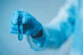 Scientist hand hold test tubes filled with blue sample chemicals in chemistry science laboratory. Glassware in medical research. Royalty Free Stock Photo