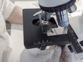 Scientist hands with microscope, examining samples and liquid. Royalty Free Stock Photo