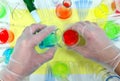 Scientist hands working on colorful science experiment. Flat lay composition Royalty Free Stock Photo