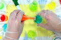 Scientist hands working on colorful science experiment. Flat lay composition Royalty Free Stock Photo