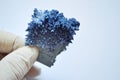 Scientist hold big blue chemical crystal in laboratory. Chemist day