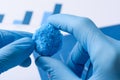 Scientist hold big blue chemical crystal