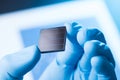Scientist hold in hand small tile of new type efficient solar cell tile