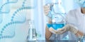 Scientist holding Florence flask with blue liquid for analysis in laboratory. Banner design