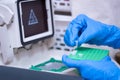 Scientist holding PCR tube put into PCR machine, Real-time PCR for identification of pathogen