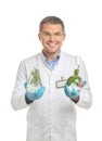 Scientist holding test flasks with plants on white background Royalty Free Stock Photo