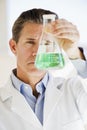 Scientist holding up jar of chemicals Royalty Free Stock Photo