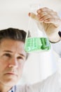 Scientist holding up jar of chemicals Royalty Free Stock Photo