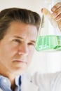 Scientist holding up jar of chemicals Royalty Free Stock Photo
