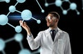 Scientist in lab coat and goggles with molecules