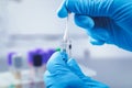 Scientist in lab collect dna sample in test tube with cotton swab