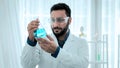 Scientist of laboratory researcher holding medical glass bottle. Analysing Chemicals in Laboratory with test tubes. Scientist Royalty Free Stock Photo