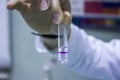 Scientist in laboratory with test tubes Phenolphthalein