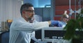 Scientist loading vials into a testing machine