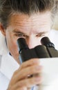 Scientist looking through microscope