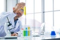 Scientist is looking to the yellow oil extraction in test tube Royalty Free Stock Photo