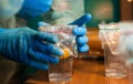 A scientist looks at a yolk in a cup.