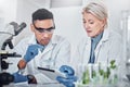 Scientist, man and woman with tablet, laboratory and ecofriendly science. Agriculture, research and scientists with Royalty Free Stock Photo