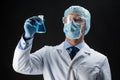 Scientist in mask holding flask with chemical Royalty Free Stock Photo