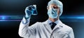 Scientist in mask holding flask with chemical Royalty Free Stock Photo