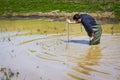 Scientist measuring environmental water quality in a wetland