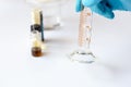 Scientist Measuring 10 ml Solvent in Graduated Cylinder for TLC Mobile Phase Royalty Free Stock Photo